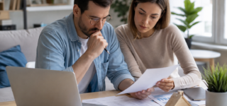 Couple analysant la rentabilité d’un investissement immobilier sur un ordinateur
